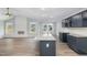 A modern, eat-in kitchen boasts an island with granite countertops and stainless steel appliances at 106 Burnello Ct, Princeton, NC 27569