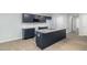 Modern kitchen featuring granite countertops, navy cabinets, and an island with a sink at 106 Burnello Ct, Princeton, NC 27569