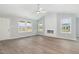 Bright living room featuring hard surface flooring, high ceilings, many windows and white fireplace at 106 Burnello Ct, Princeton, NC 27569