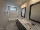 Bathroom with tile floors, dual sink vanity, shower, and bright lighting at 106 Roma Gora Ct, Princeton, NC 27569