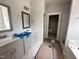 Bathroom featuring double vanity, framed mirrors, and walk-in shower at 106 Roma Gora Ct, Princeton, NC 27569