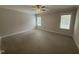 Bright bedroom featuring two windows, neutral carpet, and natural light at 106 Roma Gora Ct, Princeton, NC 27569