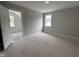 Unfinished room featuring a window and white trim, with an open doorway leading to another room at 106 Roma Gora Ct, Princeton, NC 27569