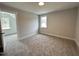 Bright bedroom featuring neutral paint, large window, and plush carpet flooring at 106 Roma Gora Ct, Princeton, NC 27569
