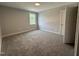 This bedroom has plush carpet, a window for natural light, neutral colors, and crisp, white trim at 106 Roma Gora Ct, Princeton, NC 27569