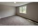 A bright bedroom with neutral colors, comfortable carpet, and a window letting in natural light at 106 Roma Gora Ct, Princeton, NC 27569