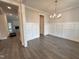 Bright dining room showcasing wainscoting, hard wood floors, and modern chandelier at 106 Roma Gora Ct, Princeton, NC 27569
