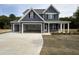 Beautiful two-story home with a three car garage, covered porch, and charming curb appeal at 106 Roma Gora Ct, Princeton, NC 27569
