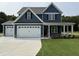 Charming two-story home features a three-car garage, covered porch, and blue siding at 106 Roma Gora Ct, Princeton, NC 27569