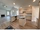 Open concept kitchen features grey cabinets, stainless steel appliances, and a kitchen island at 106 Roma Gora Ct, Princeton, NC 27569