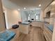 Spacious kitchen features grey cabinets, an island, hardwood floors, and stainless steel appliances at 106 Roma Gora Ct, Princeton, NC 27569