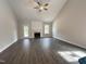 Open living room features a vaulted ceiling, fireplace with white mantel, and hardwood floors at 106 Roma Gora Ct, Princeton, NC 27569
