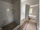 Bathroom featuring tile shower, tub, and view into bedroom at 106 Roma Gora Ct, Princeton, NC 27569
