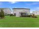 Large backyard with green grass, a screened porch, and mature landscaping at 108 E Fountainhead Ln, Garner, NC 27529