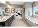 This bathroom features a double sink vanity, a soaking tub and is open to the main bedroom at 108 E Fountainhead Ln, Garner, NC 27529