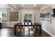 Elegant dining room featuring a dark wood table, seating for six, and access to outdoor space at 108 E Fountainhead Ln, Garner, NC 27529