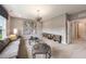 Modern living room with gray sofa, accent wall, and stylish coffee tables at 108 E Fountainhead Ln, Garner, NC 27529