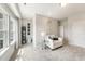 Cozy sitting area with white armchair, side table, natural light, and neutral decor at 108 E Fountainhead Ln, Garner, NC 27529