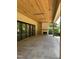 Spacious outdoor living with stone patio, wood ceilings, fireplace and sliding glass doors at 1116 Kimberly Dr, Raleigh, NC 27609