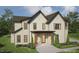 Render of a two-story brick home with a covered front porch, black trim, and professional landscaping at 1116 Kimberly Dr, Raleigh, NC 27609