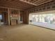 Unfinished living room area showcasing framing for the fireplace and sliding glass doors to the backyard at 1116 Kimberly Dr, Raleigh, NC 27609