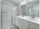 Bathroom with a glass enclosed shower and double sink vanity featuring a large mirror and modern fixtures at 112 Remington Woods Dr, Wake Forest, NC 27587