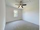 Bright bedroom features a ceiling fan, neutral carpet and walls, and natural light from a window at 112 Remington Woods Dr, Wake Forest, NC 27587