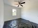 Spare bedroom with ceiling fan and view of treeline through a single window at 112 Remington Woods Dr, Wake Forest, NC 27587
