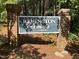 Remington Woods community sign framed by brick pillars, nestled among towering trees at 112 Remington Woods Dr, Wake Forest, NC 27587