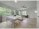 Bright dining room and living room area with lots of windows and light wood flooring at 112 Remington Woods Dr, Wake Forest, NC 27587