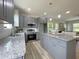 Modern gray kitchen featuring stainless steel appliances and granite countertops at 112 Remington Woods Dr, Wake Forest, NC 27587