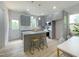 Modern gray kitchen with stainless steel appliances, island with granite countertops, and pendant lighting at 112 Remington Woods Dr, Wake Forest, NC 27587