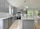 Modern gray kitchen with stainless steel appliances and bright natural light at 112 Remington Woods Dr, Wake Forest, NC 27587