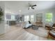 Bright open-concept living room with lots of natural light, modern decor, and an adjacent gray kitchen at 112 Remington Woods Dr, Wake Forest, NC 27587