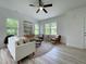 Living room with a round jute rug, two mid-century style chairs, and a white couch at 112 Remington Woods Dr, Wake Forest, NC 27587