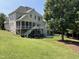 Spacious backyard with a screened porch, deck, patio, and lush landscaping at 113 Woodland Ridge Ct, Cary, NC 27519