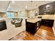 Finished basement featuring a bar area with granite countertops, seating, and a cozy adjacent seating area at 113 Woodland Ridge Ct, Cary, NC 27519