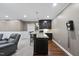 Basement bar area with granite countertops, dark wood cabinets, and seating perfect for entertaining guests at 113 Woodland Ridge Ct, Cary, NC 27519