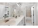 Elegant bathroom with double sink vanity, large mirror, and a view of the bathtub and adjacent room at 113 Woodland Ridge Ct, Cary, NC 27519