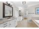 Elegant bathroom features double vanities with granite countertops, neutral tile flooring, and a walk-in closet at 113 Woodland Ridge Ct, Cary, NC 27519