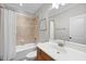 Bathroom features a vanity with a sink, toilet, mirror and tub/shower combination with neutral tile at 113 Woodland Ridge Ct, Cary, NC 27519