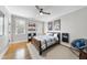 Well-lit bedroom offers ample space, hardwood floors, and charming decor at 113 Woodland Ridge Ct, Cary, NC 27519