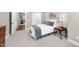 Comfortable bedroom offers ample space, soft textures, and access to the home gym at 113 Woodland Ridge Ct, Cary, NC 27519