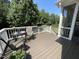 Outdoor deck with composite decking, furniture set, flowers and view of landscaped yard at 113 Woodland Ridge Ct, Cary, NC 27519