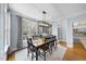 Bright dining room with hardwood floors, large windows, and modern light fixture at 113 Woodland Ridge Ct, Cary, NC 27519