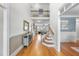 Welcoming foyer with hardwood floors, staircase, console table, and wrought iron banister and a view into the living room at 113 Woodland Ridge Ct, Cary, NC 27519