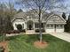 Attractive two-story home featuring well-maintained landscaping, a manicured lawn, and an attached two-car garage at 113 Woodland Ridge Ct, Cary, NC 27519
