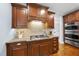 Elegant kitchen with wood cabinets, granite counters, tile backsplash, and stainless appliances at 113 Woodland Ridge Ct, Cary, NC 27519