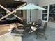 Outdoor patio featuring dining seating with umbrella and stairs up to the house at 113 Woodland Ridge Ct, Cary, NC 27519