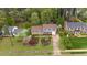 Aerial view of a traditional home with a well-manicured front lawn at 1205 Country Ridge Dr, Raleigh, NC 27609